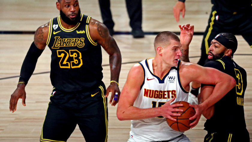 Sep 20, 2020; Lake Buena Vista, Florida, USA; Denver Nuggets center Nikola Jokic (15) drives to the basket against Los Angeles Lakers forward Anthony Davis (3) and forward LeBron James (23) during the first quarter in game two of the Western Conference Finals of the 2020 NBA Playoffs at AdventHealth Arena. Mandatory Credit: Kim Klement-USA TODAY Sports